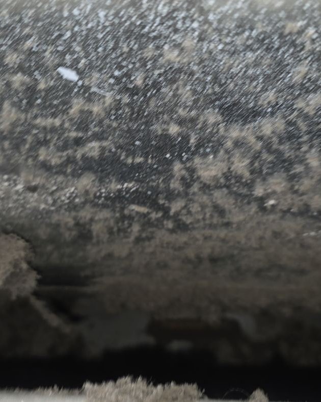 Dryer vent duct interior matted with lint before cleaning