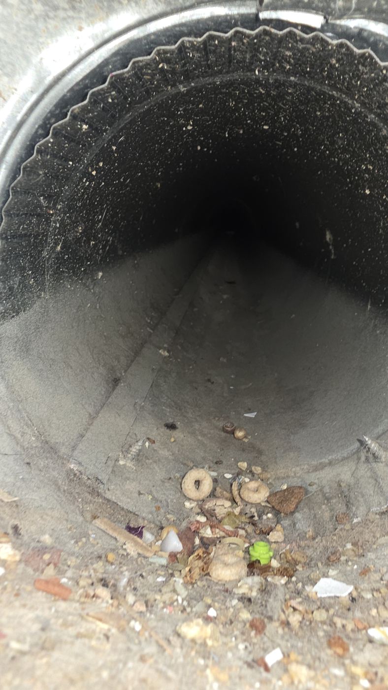 Air duct interior full of debris before cleaning